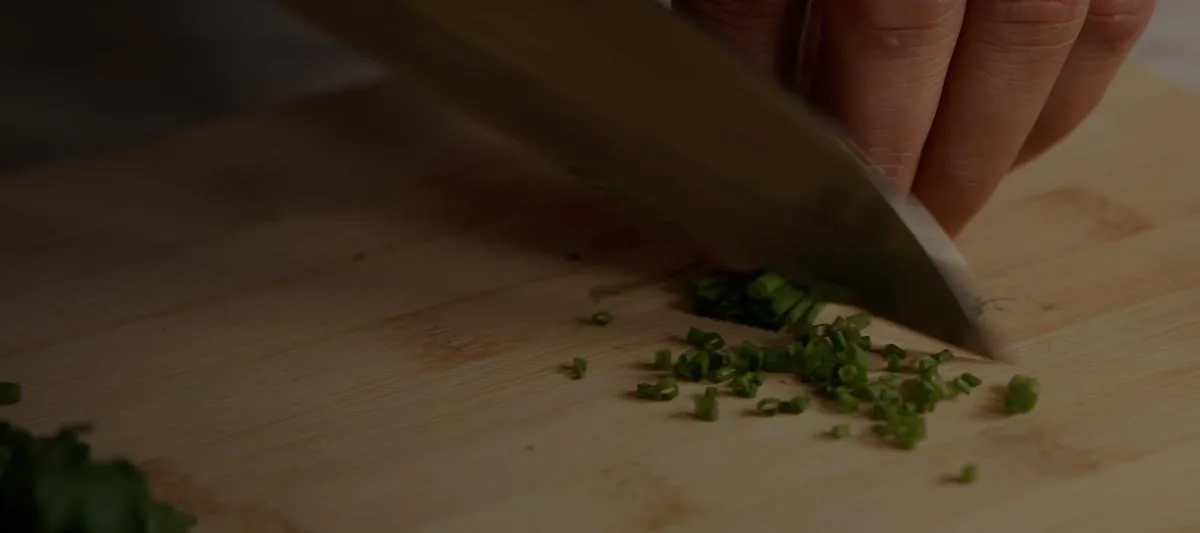 A CookUnity chef preparing a dish in the kitchen.